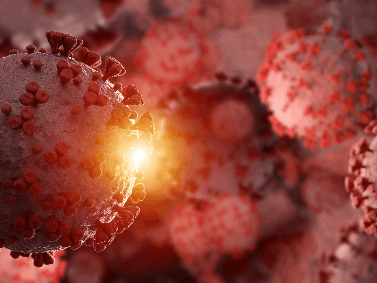 Illustrasjon av koronavirus med røde pigger og lysglimt i bakgrunnen.